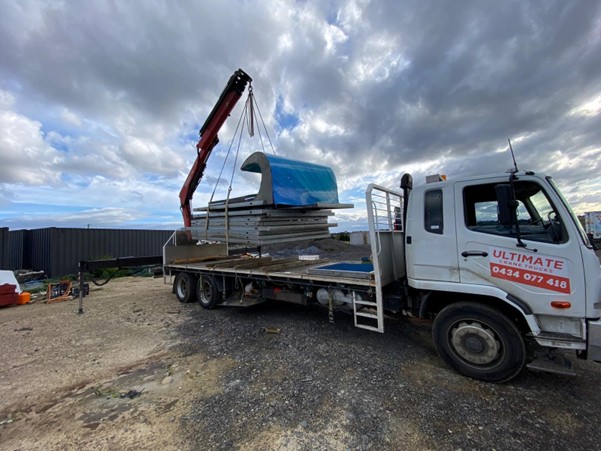 Heavy haulers in Melbourne lifting oversized industrial materials using a crane truck. Credit: Ultimate Crane Trucks