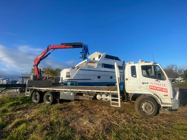 Crane lorry lifting marine equipment onto a vessel in Melbourne